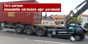 TIRIN ALTINA GİREN OTOMOBİL, İŞ MAKİNESİYLE ÇIKARILABİLDİ